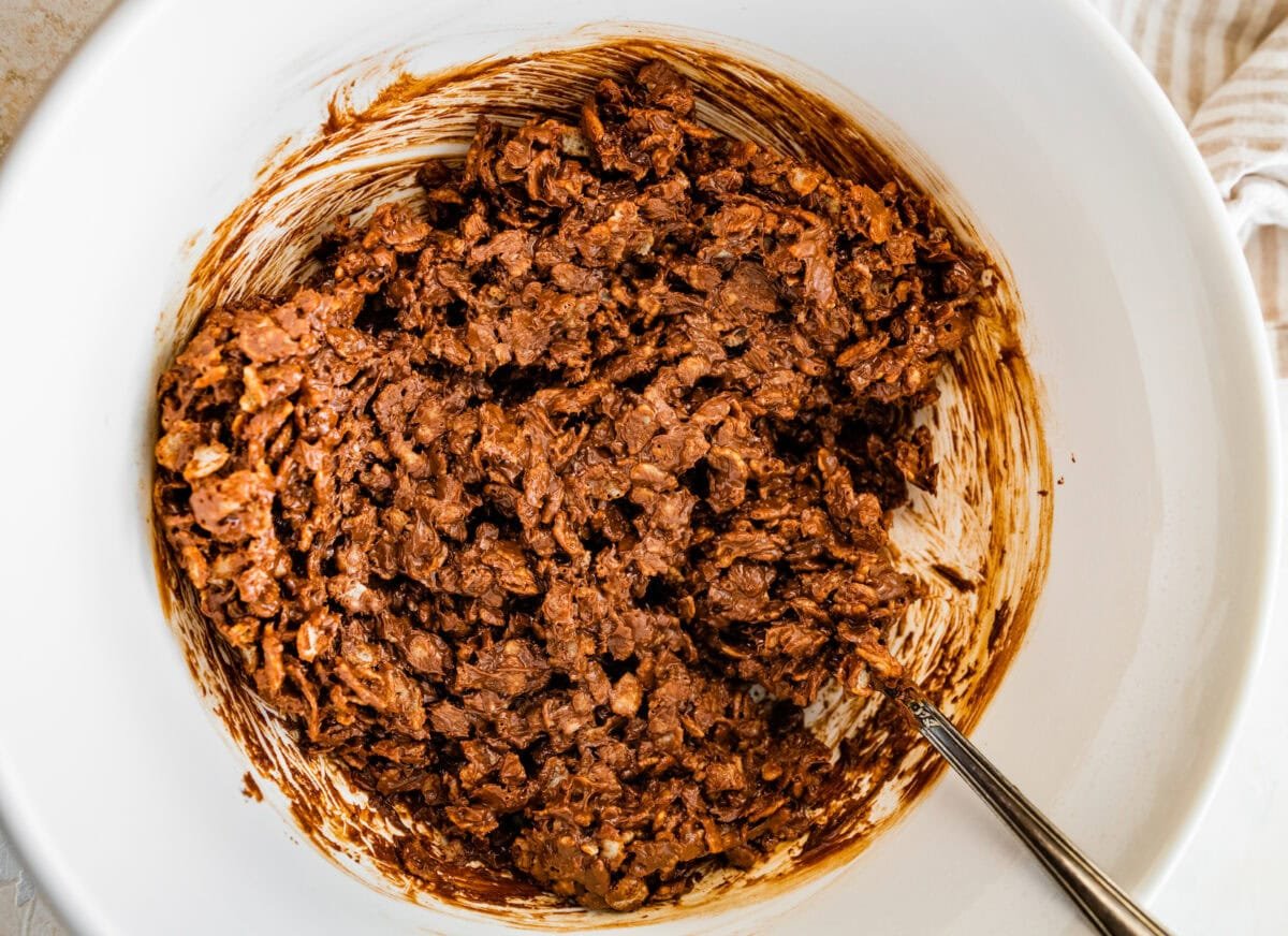chocolate crunch bar mixture in mixing bowl with spoon.