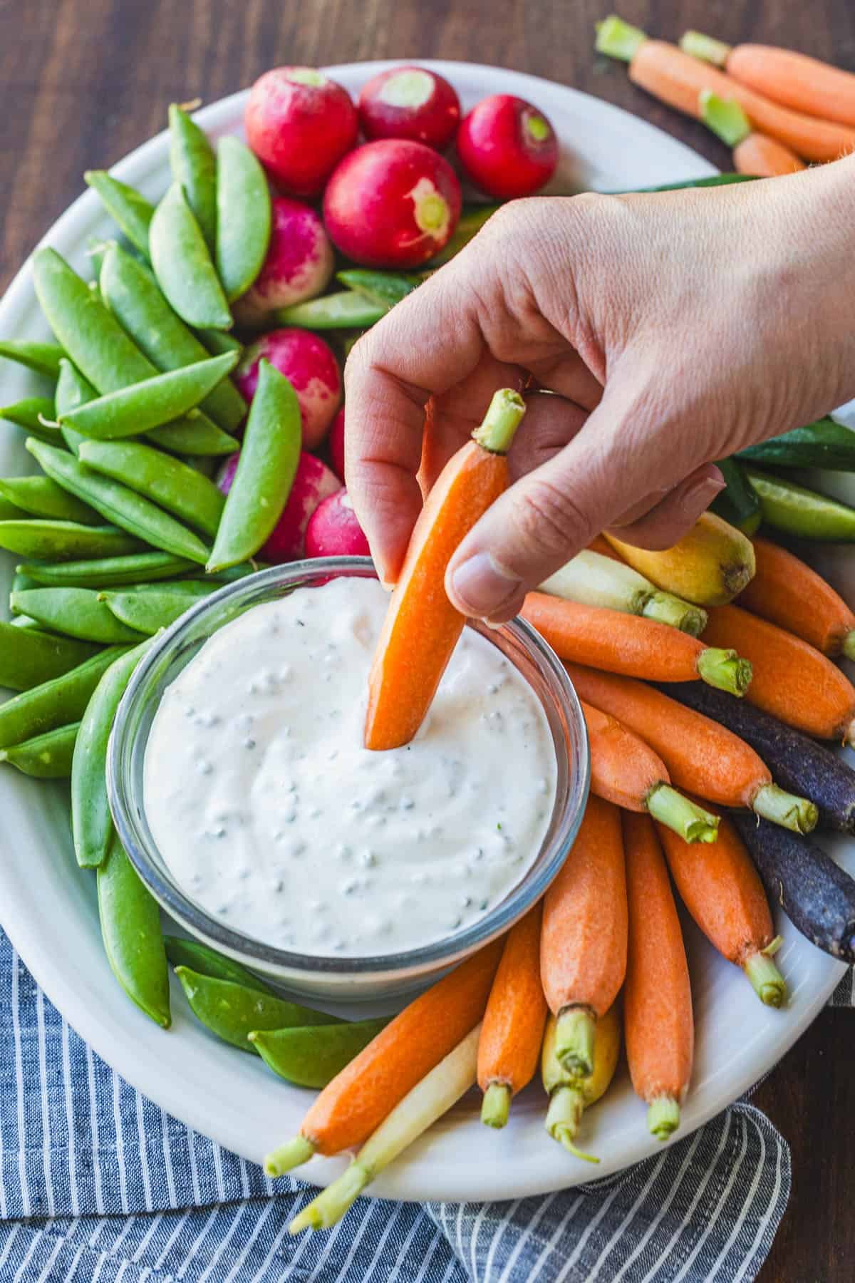 Easy Ranch Dip Recipe is ready in under 5 minutes with the best flavor and perfect thickness for dipping fresh vegetables and finger foods. Dipping ray carrots into homemade Ranch Dip from a veggie tray