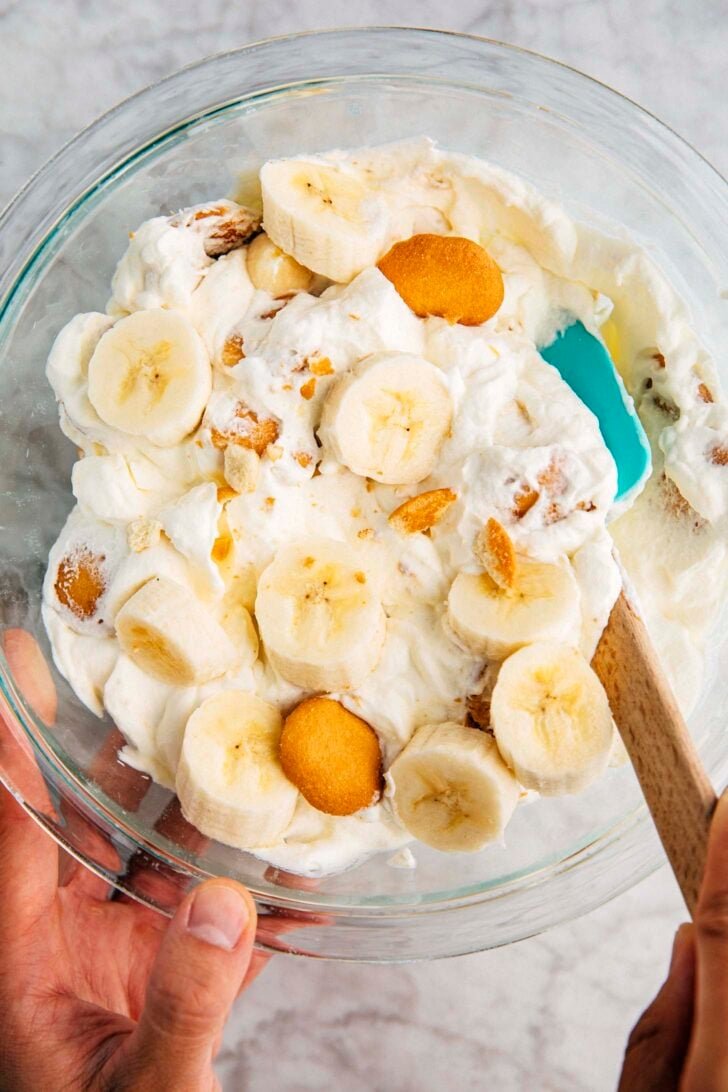 photo of banana pudding recipe ingredients being mixed in a clear glass bowl