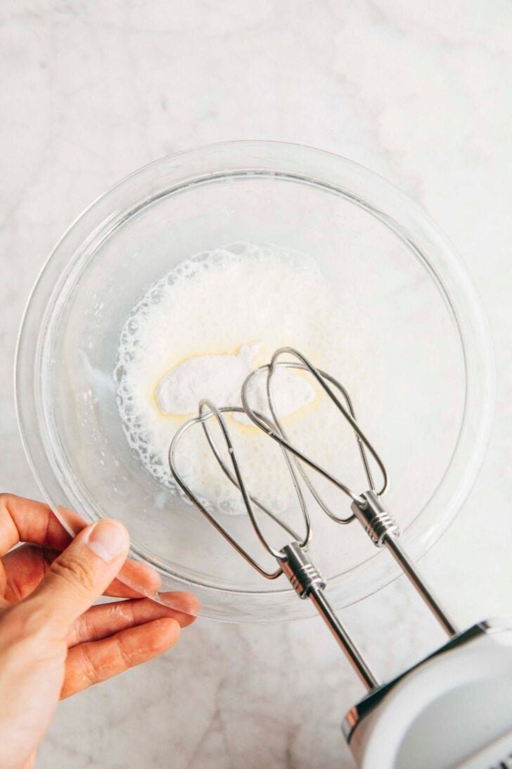 Photo of Michelle from Hummingbird High adding the instant pudding mix to the condensed milk and water mixture