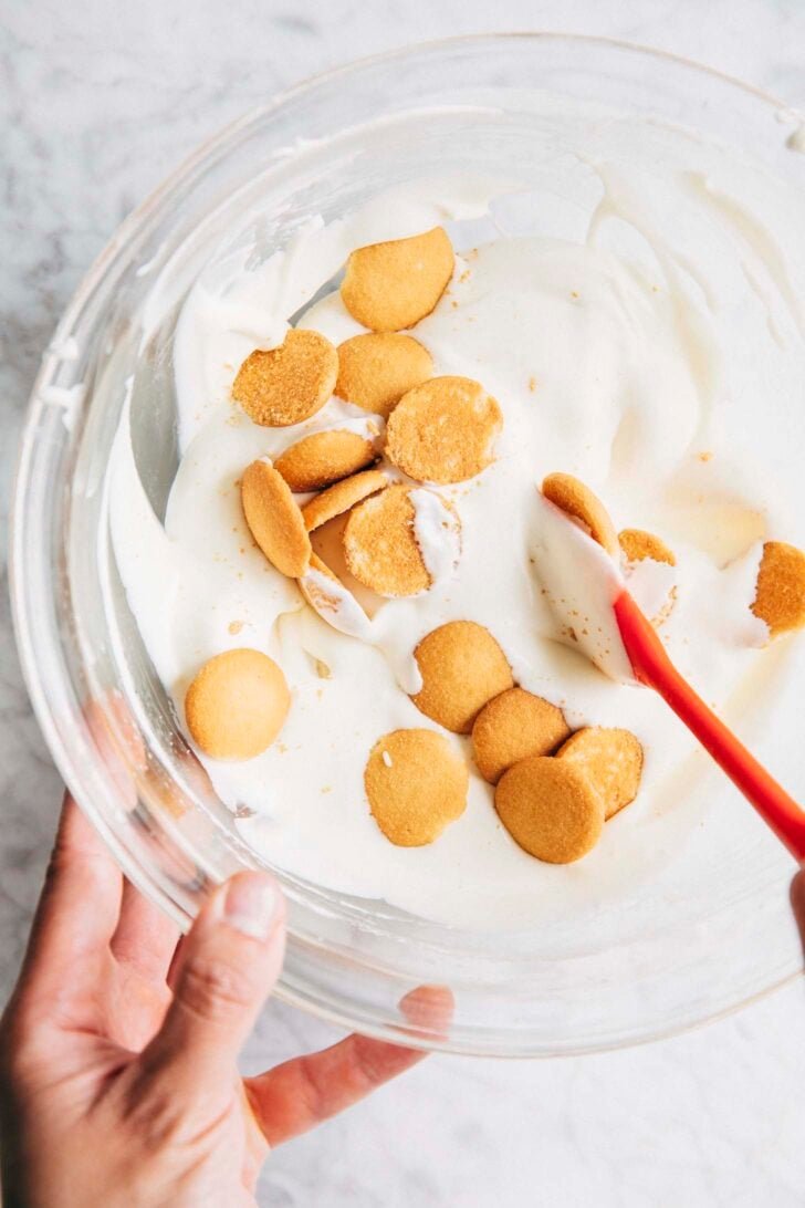 Photo showing Michelle from Hummingbird High mixing the vanilla wafers into the pudding