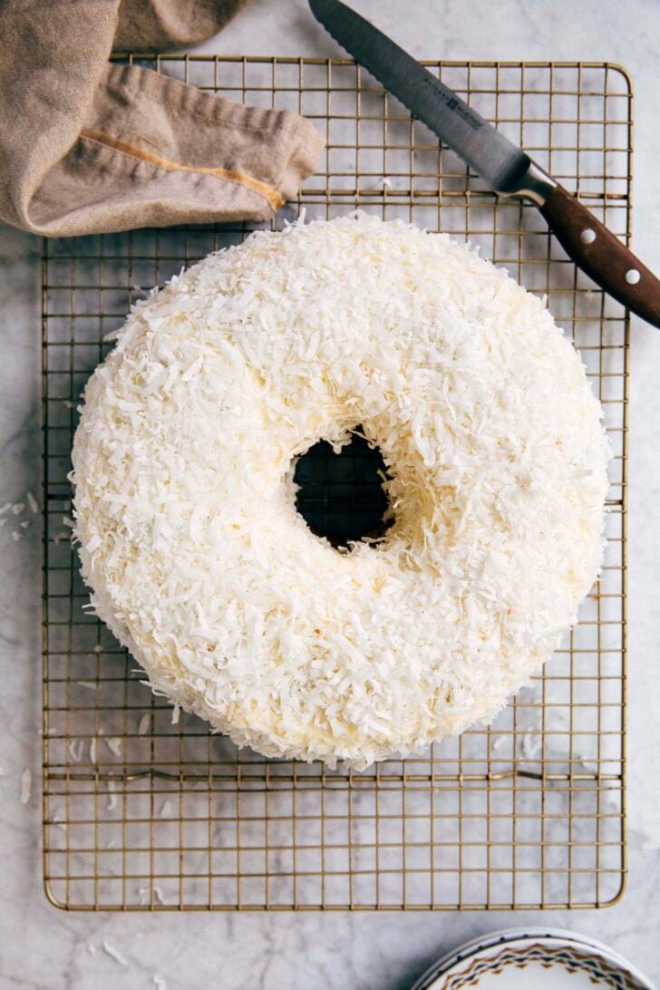 photo of coconut bundt cake on a gold wire rack