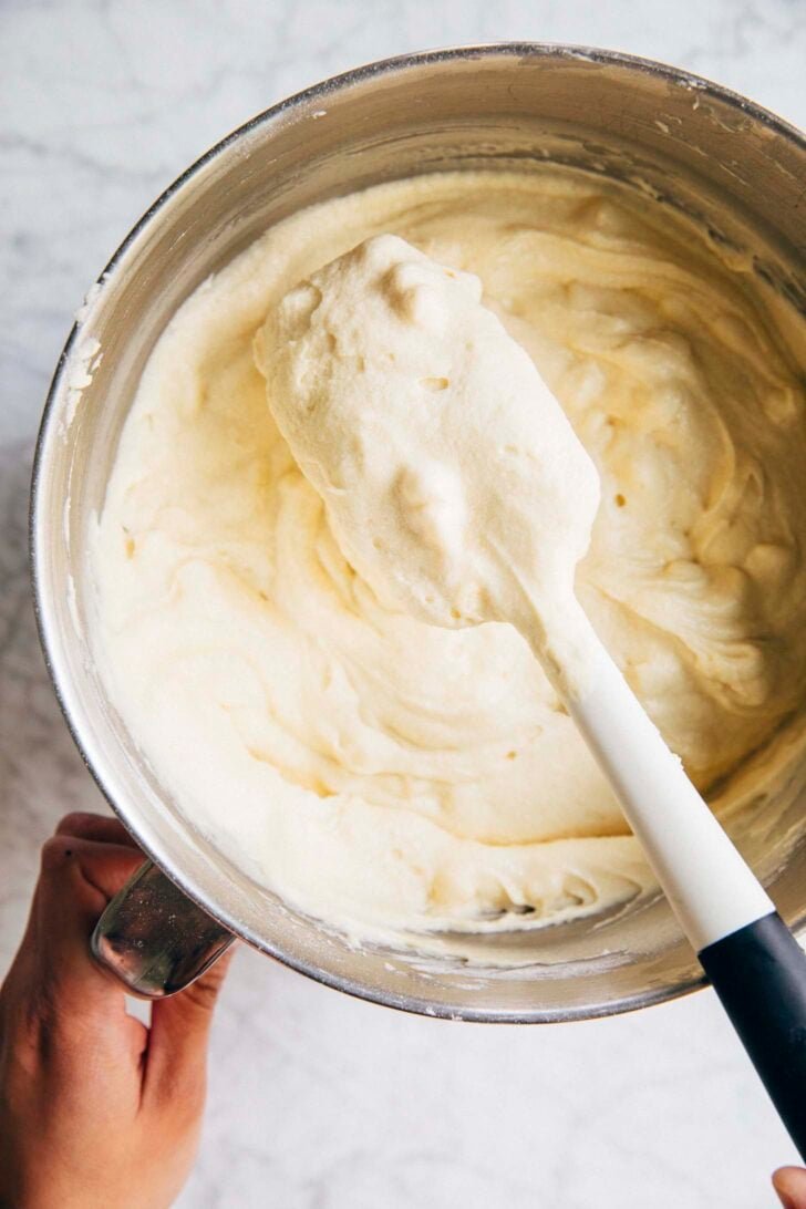 photo showing the unbaked coconut tom cruise coconut cake batter in a silver mixing bowl