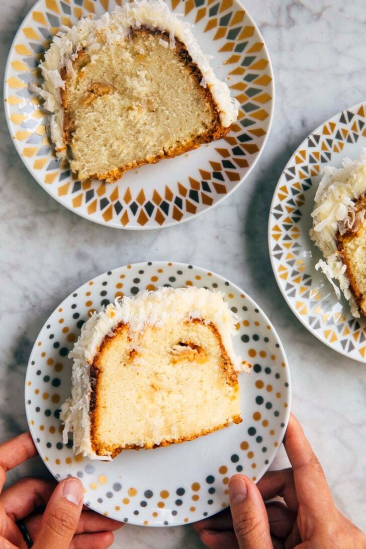 photo of three slices of coconut bundt cake on patterned plates