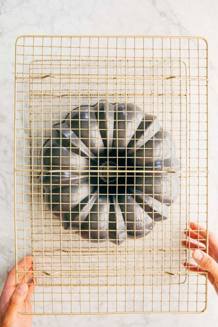 photo showing the second step of turning the cake out of its bundt pan
