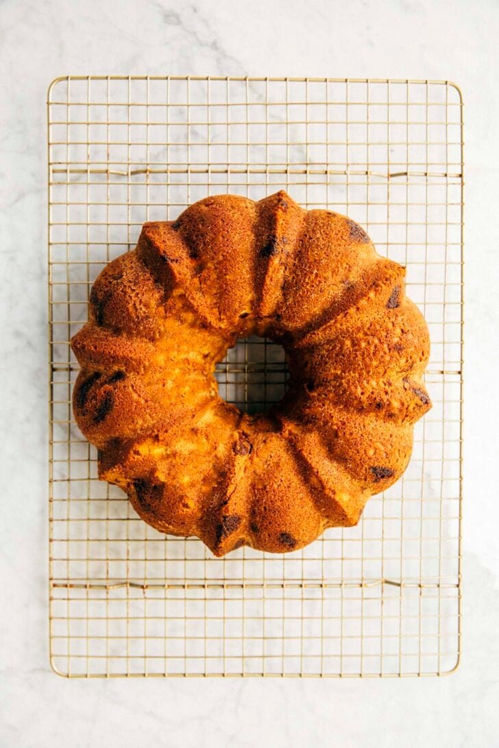 photo showing the coconut bundt cake out of the pan on a wire rack