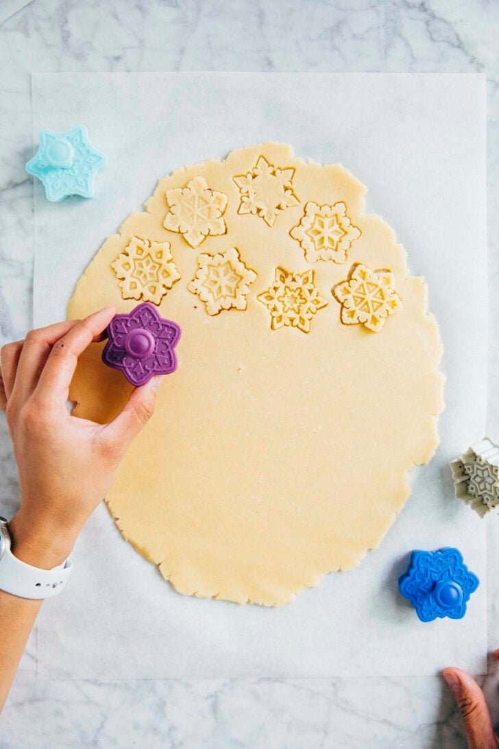 photo of michelle from hummingbird high cutting out sugar cookies from cut out sugar cookie dough