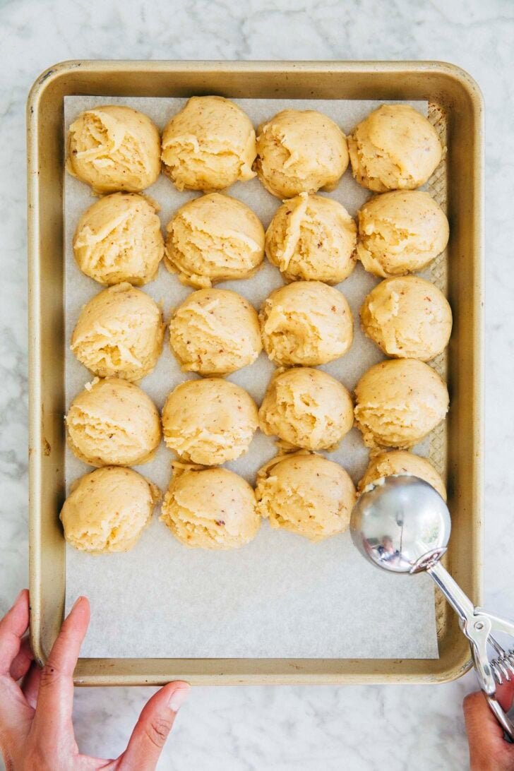 photo of michelle from hummingbird high scooping the snickerdoodle dough into cookie dough balls
