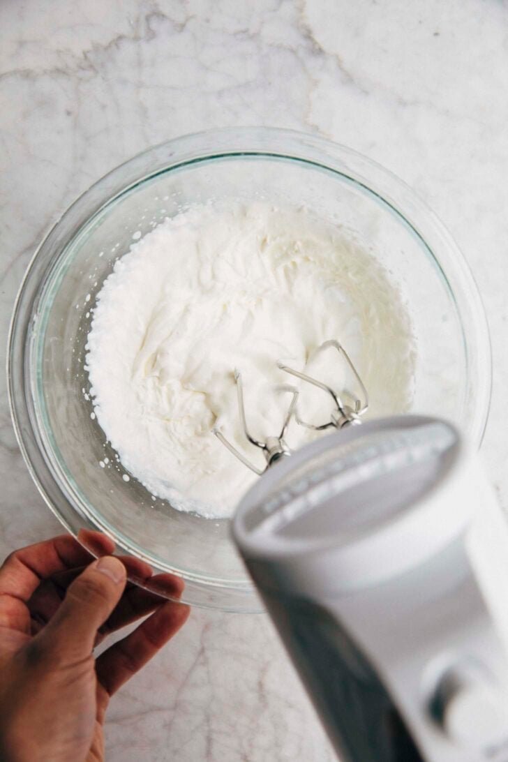 photo showing the middle stage of whipping the einspanner cream with a pourable whipped cream