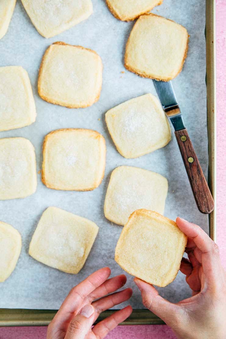 hand picking up shortbread cookie