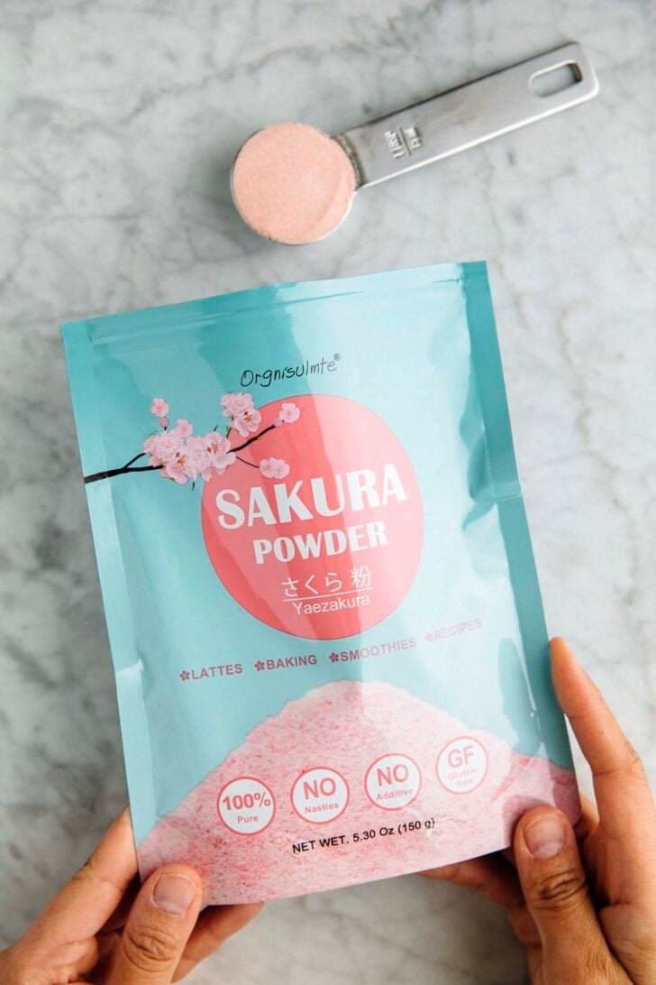 photo of opened bag of sakura powder with a tablespoon measure showing the cherry blossom powder texture