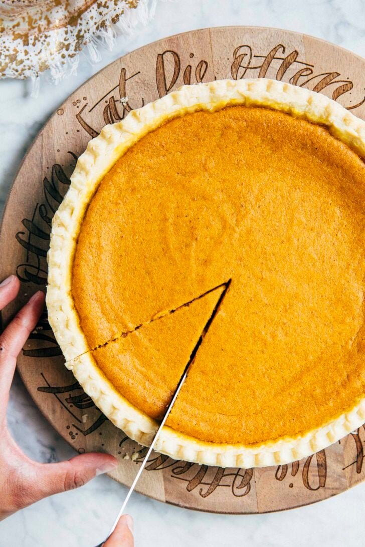 close up photo of michelle from hummingbird high slicing the cream cheese pumpkin pie