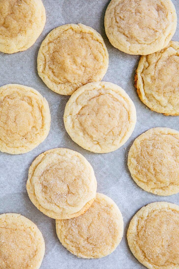 close up photo of chewy drop sugar cookies on parchment paper