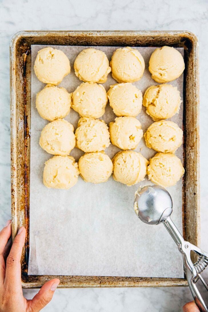 photo of drop sugar cookie dough portioned into cookie dough balls using a cookie dough scoop
