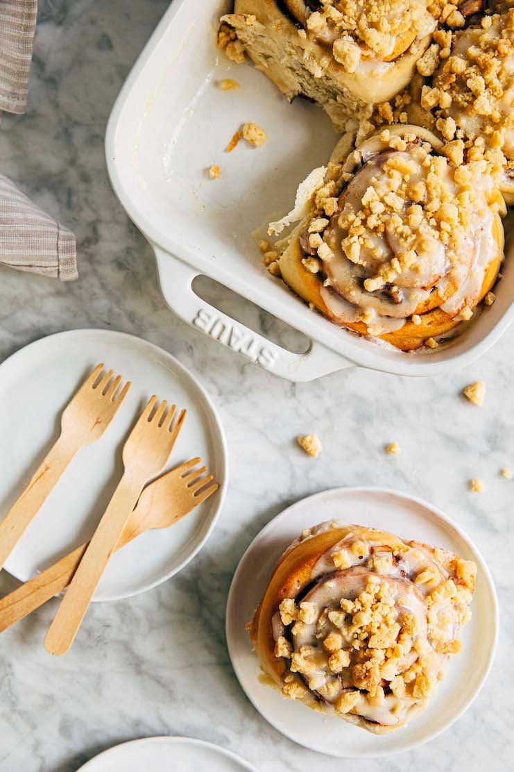 photo of apple pie cinnamon rolls with one bun on white plate