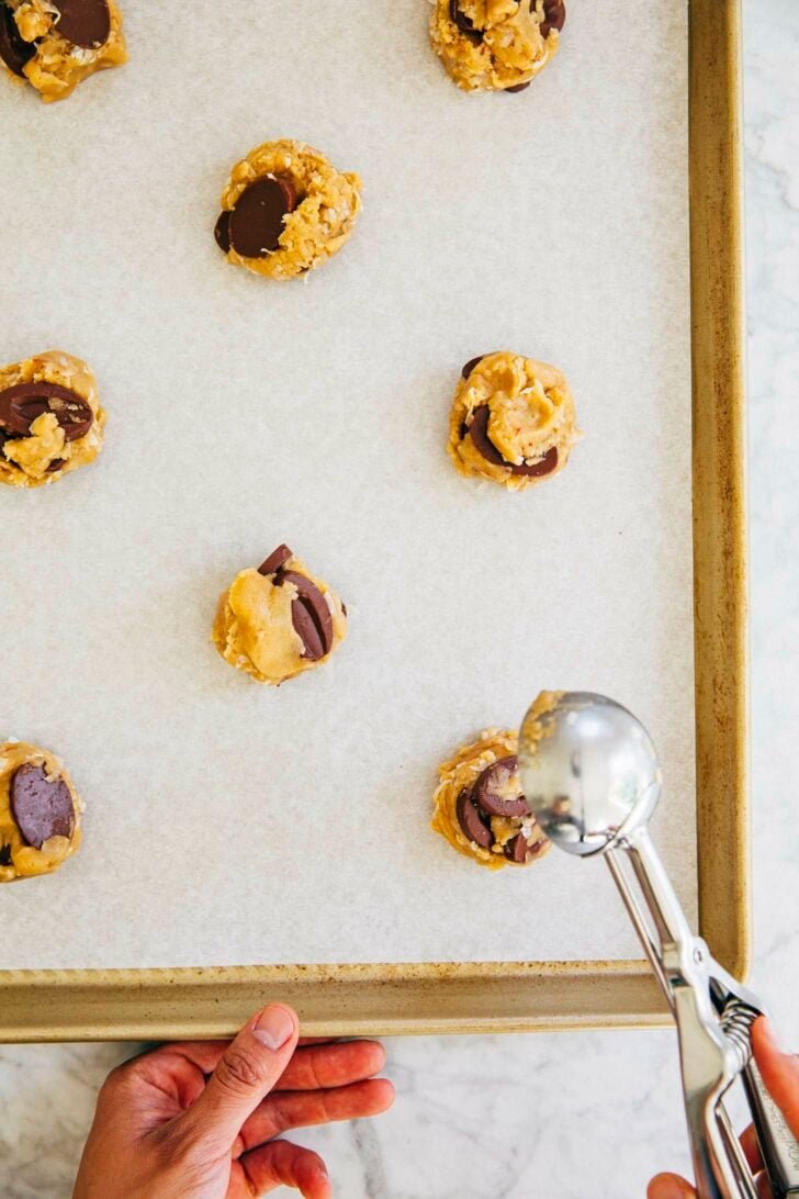 photo of Michelle from Hummingbird High scooping the coconut chocolate chip cookie dough into cookies