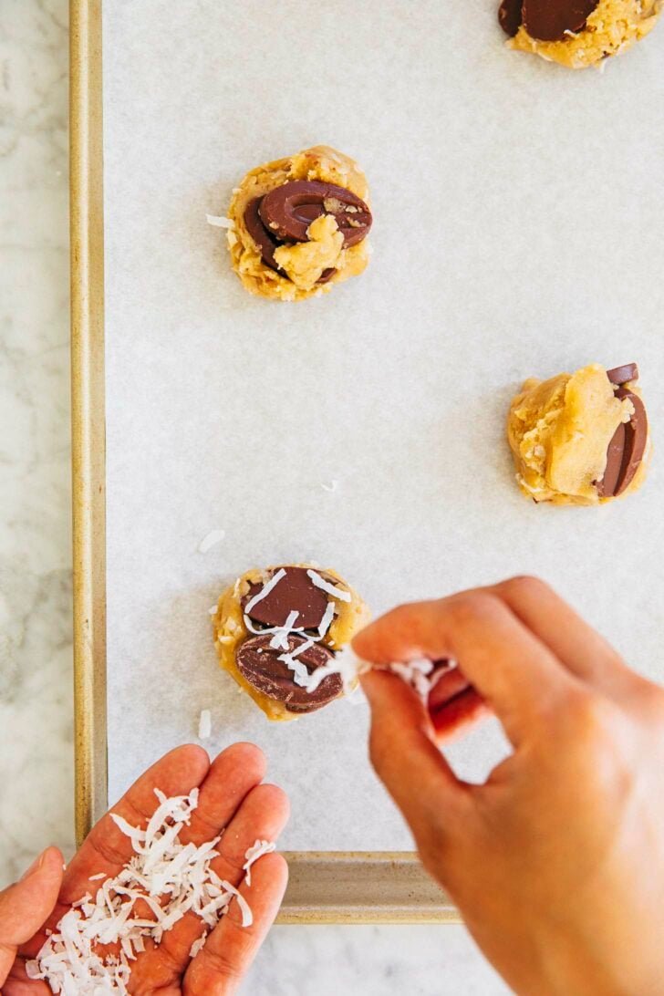 photo of michelle from hummingbird high garnish the cookie dough balls with shredded coconut