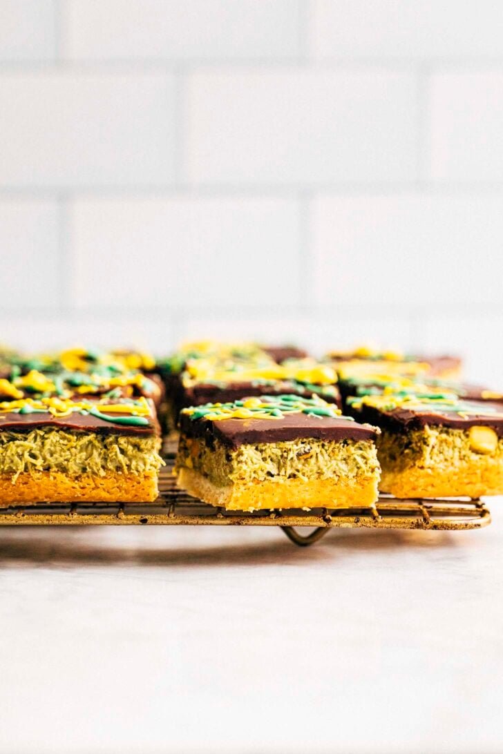 Photo of sliced Dubai chocolate millionaire bars on a gold wire rack against a white backdrop