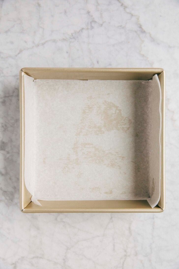 Photo of 8-inch square pan lined with parchment paper