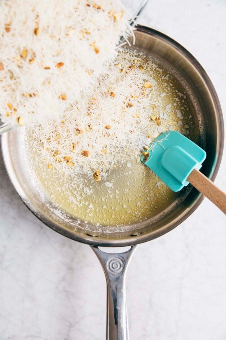Photo showing the kataifi being added to the melted butter