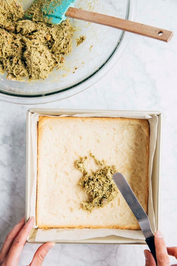 Photo of Michelle from Hummingbird High making the pistachio kataifi layer for the shortbread bars