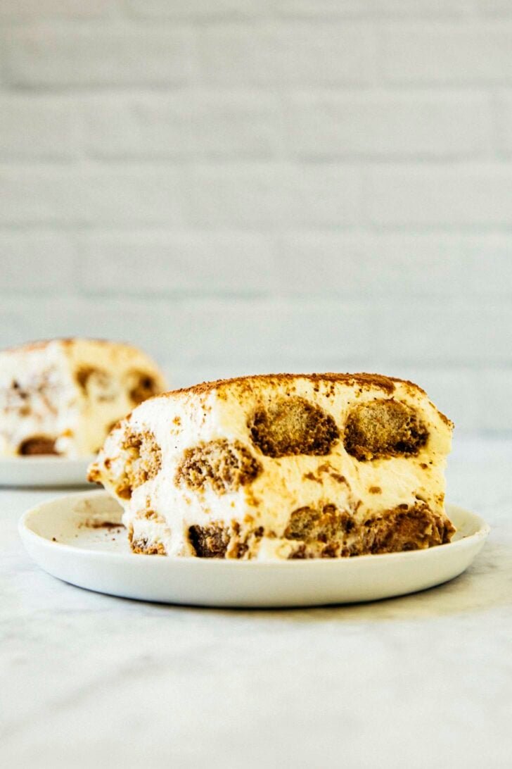 photo of a slice of tiramisu on a white plate