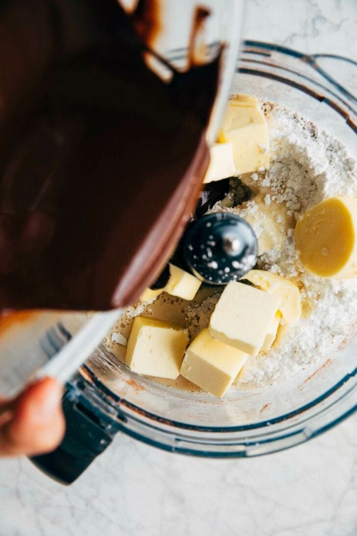 photo of michelle pouring melted chocolate over the chocolate fudge frosting ingredients