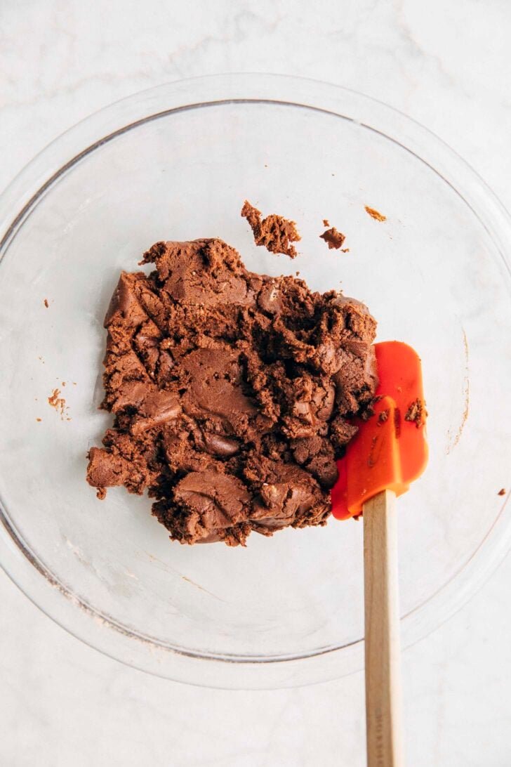 Photo showing the chocolate shortbread crust dough in a clear bowl