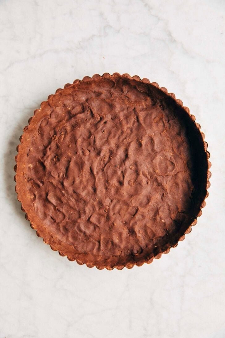 Photo showing the chocolate tart dough pressed into the pan before being baked
