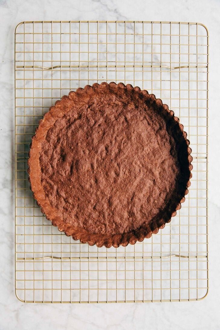 Photo showing the chocolate tart dough pressed into the pan after being baked