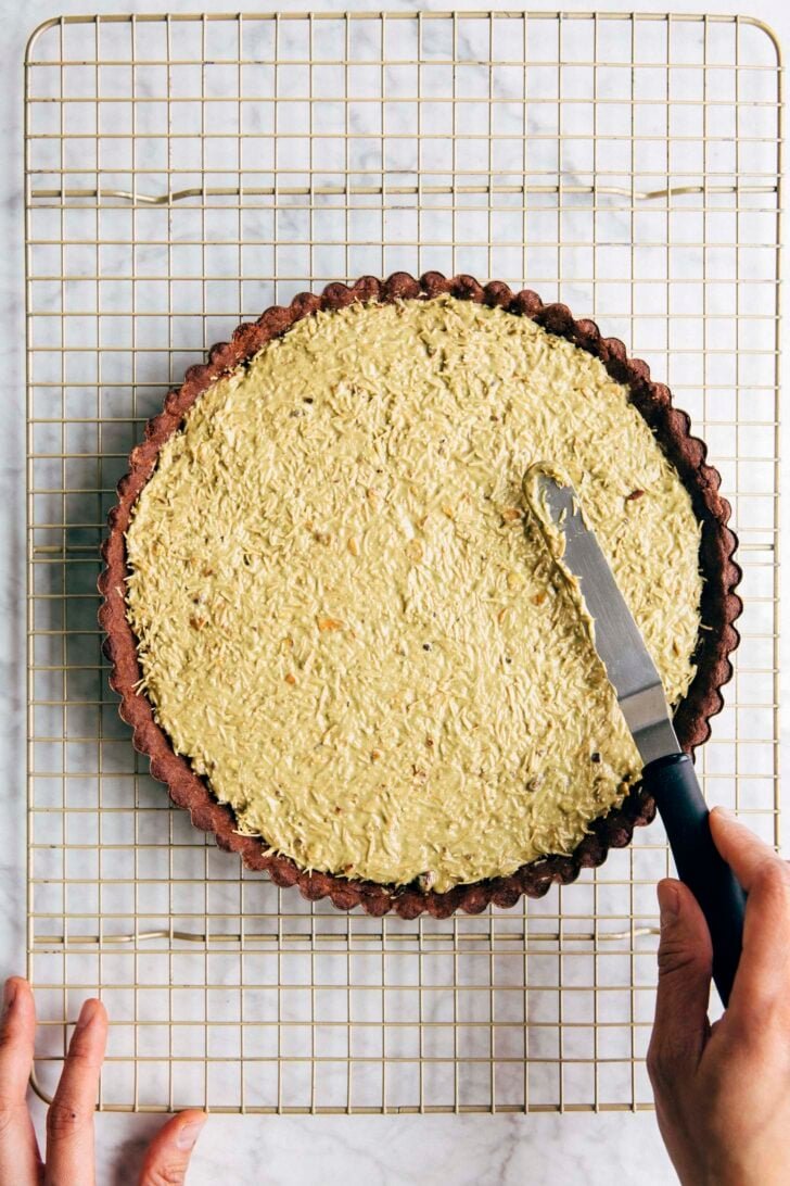 Photo showing the kataifi spread evenly in the tart crust and ready for the ganache layer