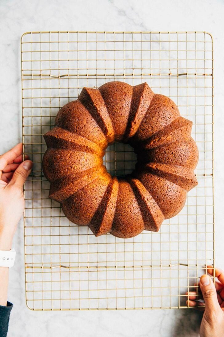photo showing the banana pudding bundt cake on a wire rack after it's been turned out from the pan