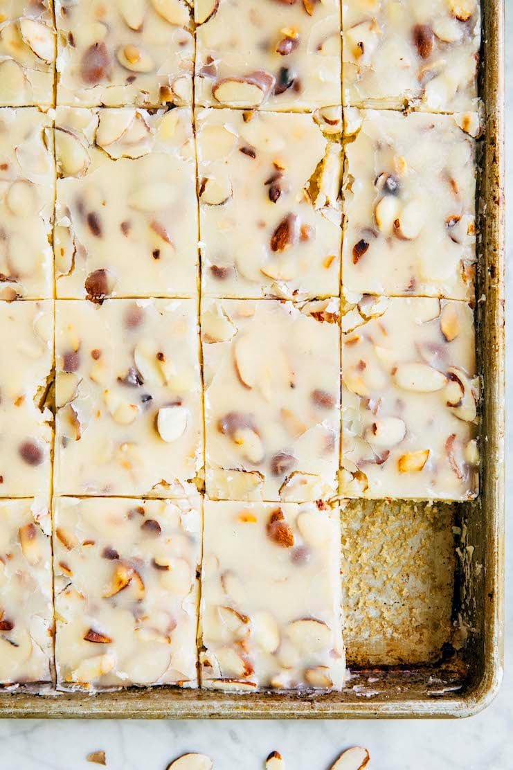 close up photo showing white texas sheet cake slices in 9 x 13 pan