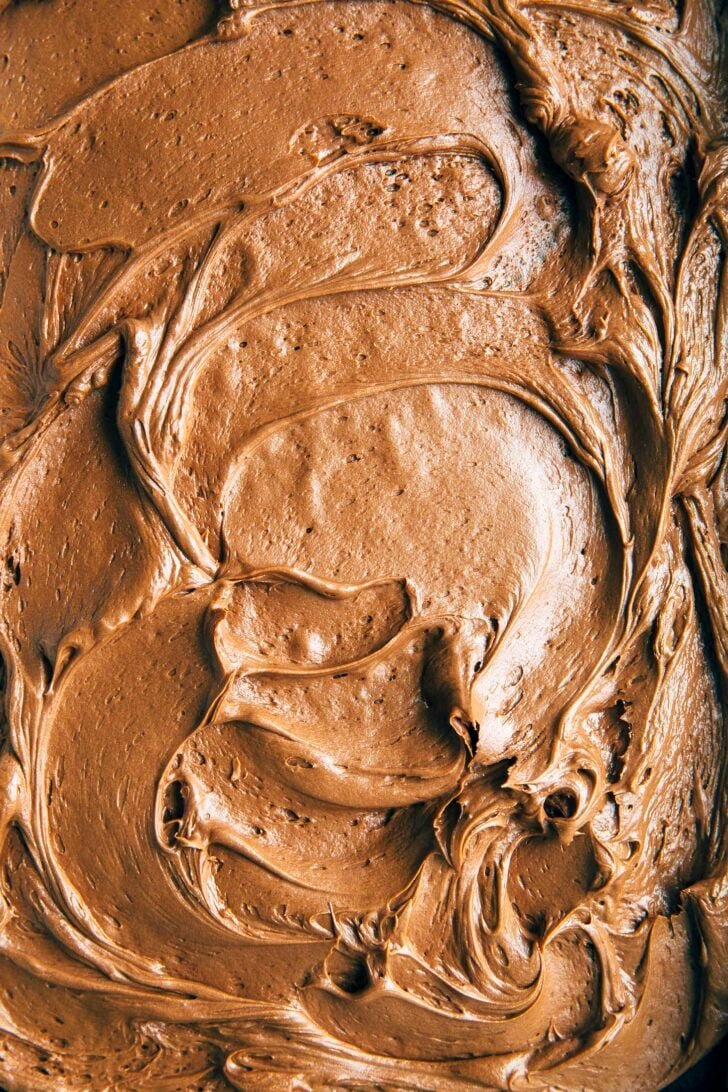 close-up shot of the chocolate cream cheese frosting swirled on a sheet cake