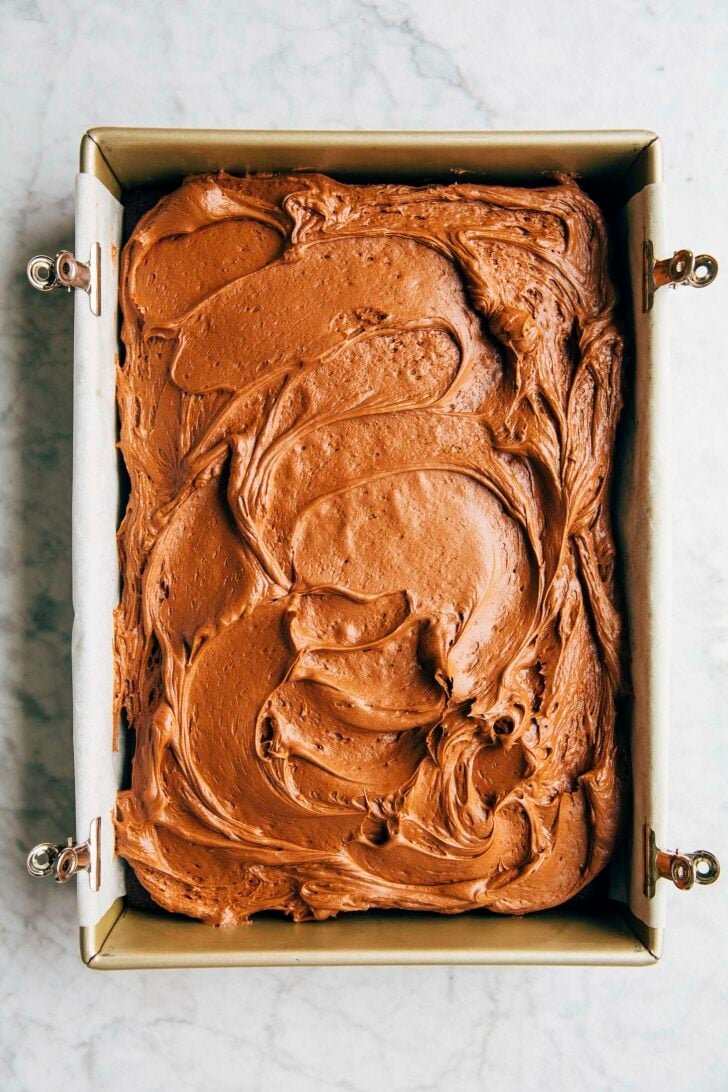 photo of the chocolate cream cheese frosting on a sheet cake in its pan