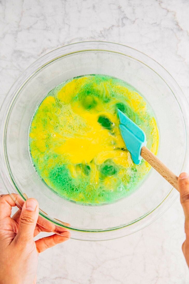 photo of michelle from hummingbird high adding the cut eggs to the cake batter