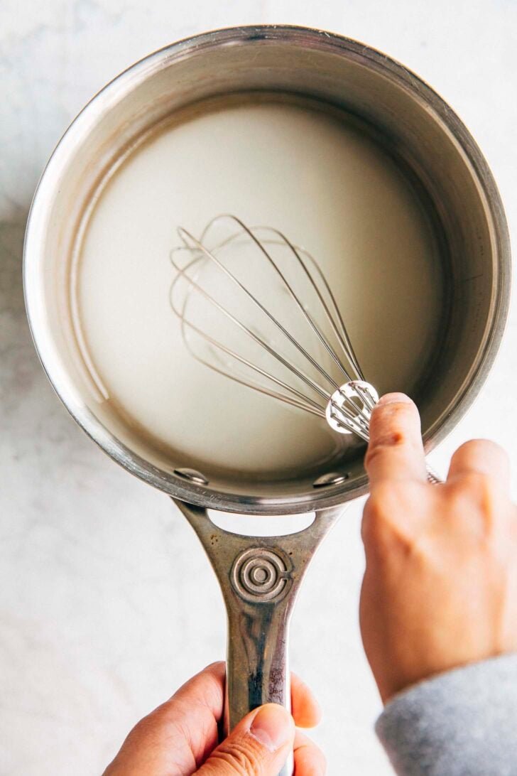 photo of the mixture showing the water and sugar mixed with a cloudy color