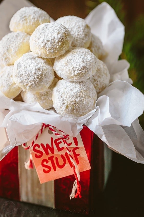 These almond snowball cookies just melt in your mouth. Perfect Christmas cookies since they look like darling little snowballs. Snowball cookies wrapped in a box for Christmas cookies gift