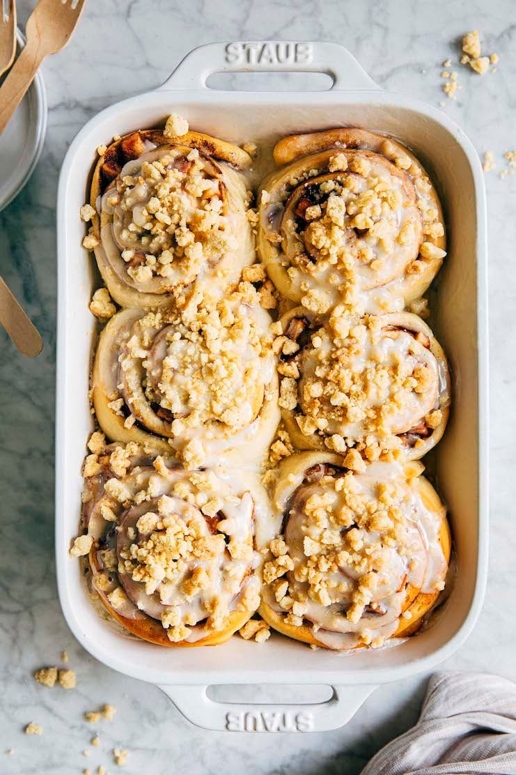 photo of apple pie cinnamon rolls in white baking pan