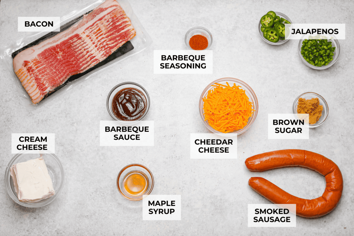 Get ready to wow your taste buds with Pig Shots! These bite-sized creations feature smoky bacon wrapped around savory sausage, filled with a creamy, flavorful cream cheese mixture. Shaped like mini shot glasses, they’re the perfect snack for game day, parties, or anytime you're looking for a unique appetizer. Overhead shot of labeled pig shot ingredients.