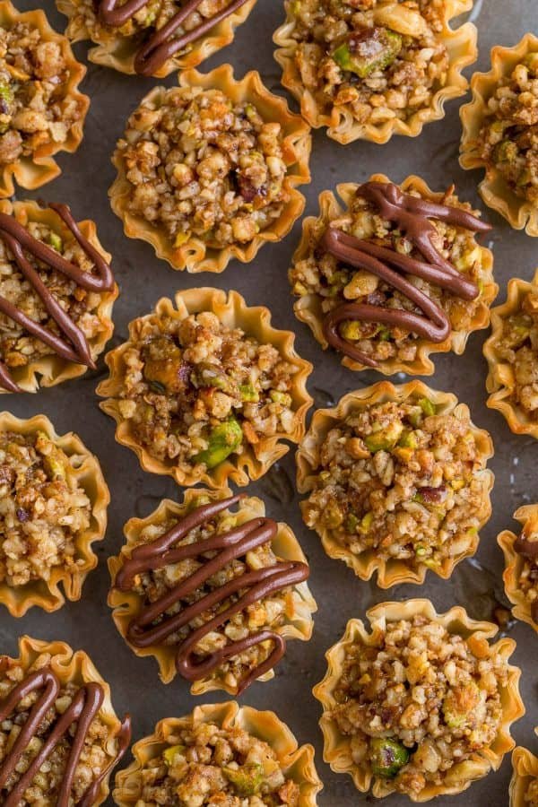 Mini Baklava Cups taste like authentic baklava but easier! The honey and lemon syrup make these baklava cups completely irresistible. A make-ahead recipe! | natashaskitchen.com