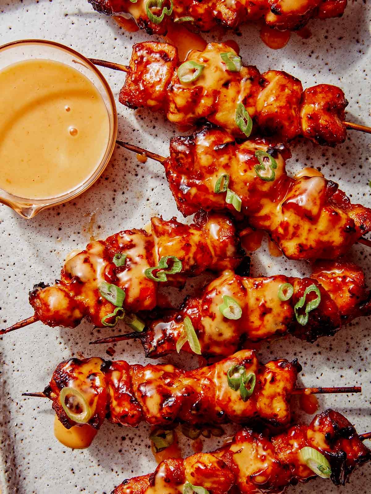 Air fryer bang bang chicken skewers on a platter.