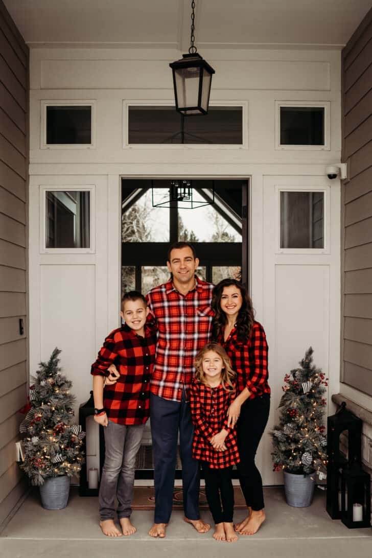 Family Smiling Natasha and family by front door