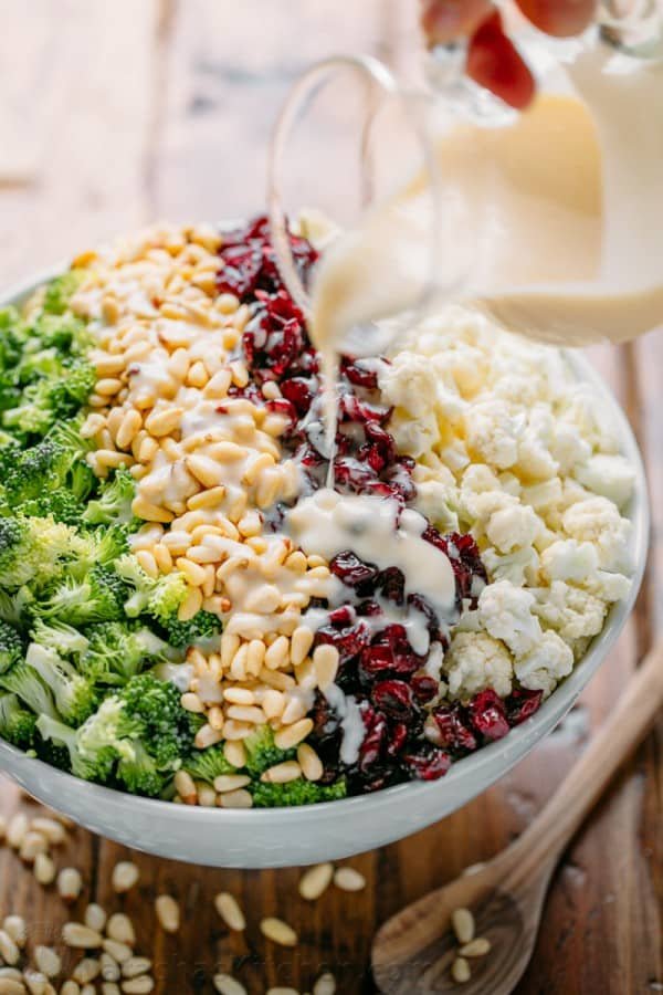 Broccoli Cauliflower Salad with honey lemon dressing always gets rave reviews. An easy, 7-ingredient favorite potluck and party salad recipe. Broccoli cauliflower salad in bowl with creamy dressing
