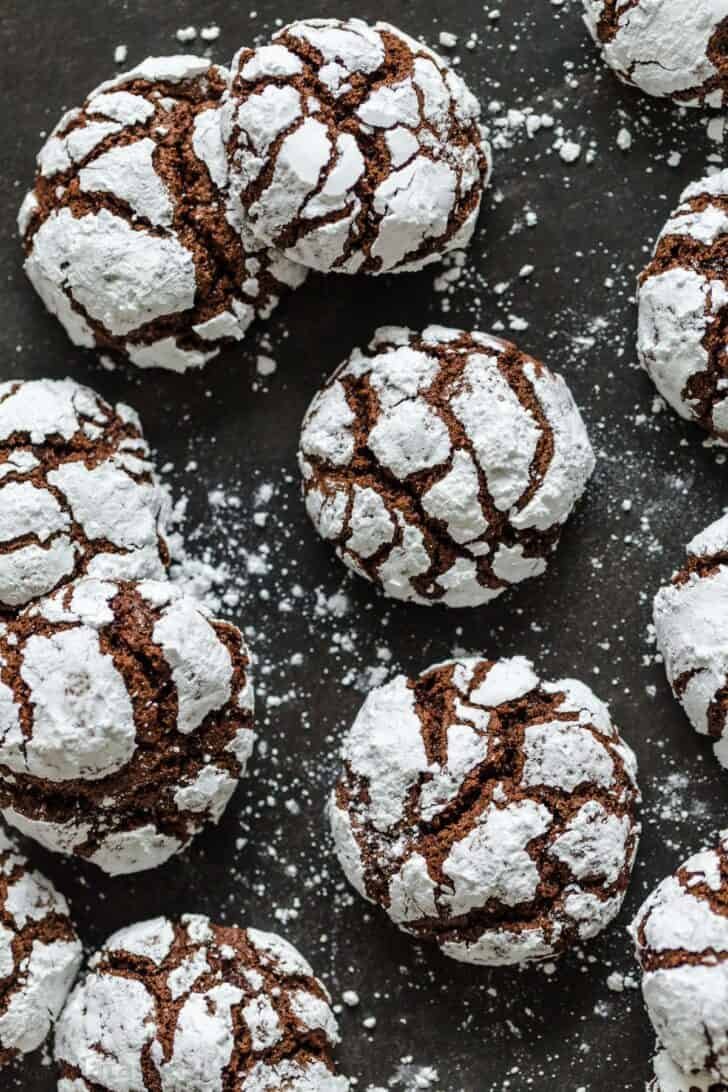 Chocolate Crinkle Cookies are like a cross between the gooiest brownie you have ever had and a crispy chocolate chip cookie Several Chocolate Crinkle Cookies on a tray