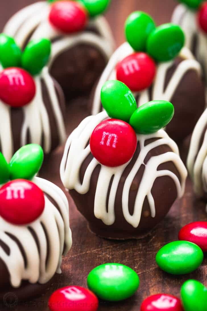 Chocolate Coconut Balls are an easy, no-bake treat. These M&M Christmas coconut candies are perfect for your holiday cookie platter. Christmas Coconut Balls decorated with m&m