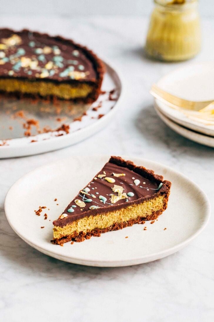 Photo of a slice of Dubai chocolate pistachio tart on a white plate