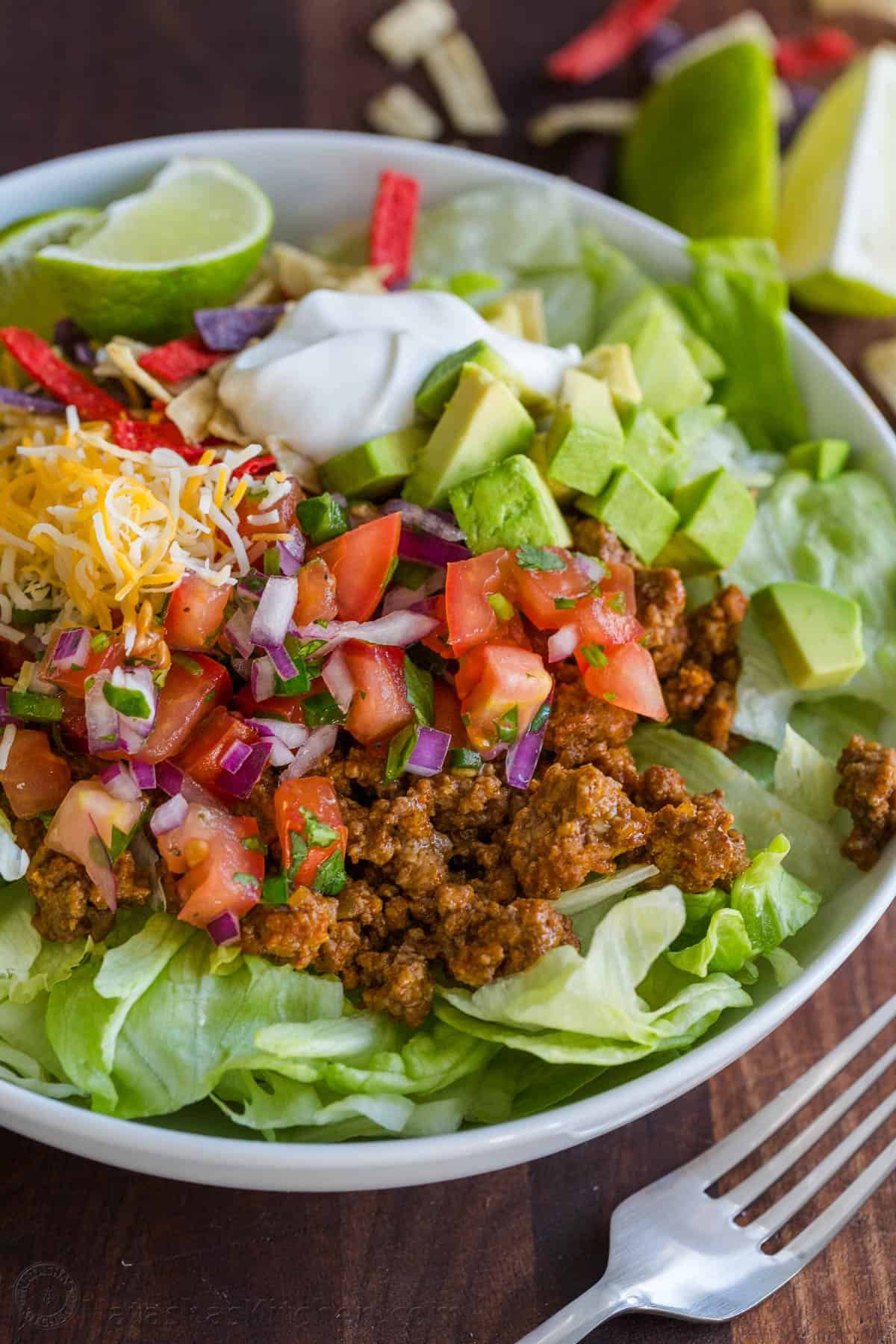 Fresh and easy Taco Salad loaded with beef, crisp lettuce, all the toppings, and the best dressing. So good served in a crispy taco salad bowl! Taco Salad Served with toppings