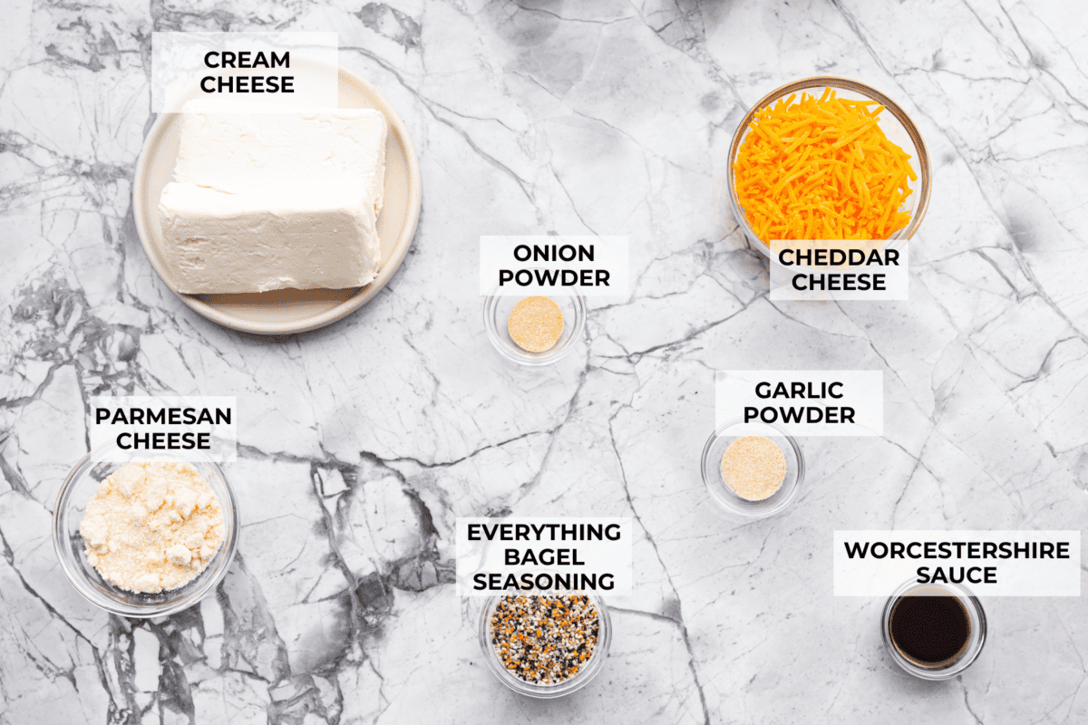This everything bagel cheese ball combines the creamy richness of cheese with the savory blend of everything bagel seasoning! It's an irresistible appetizer you can serve with crackers, bagel chips, or veggies! Everyone will love it! Overhead shot of labeled ingredients.