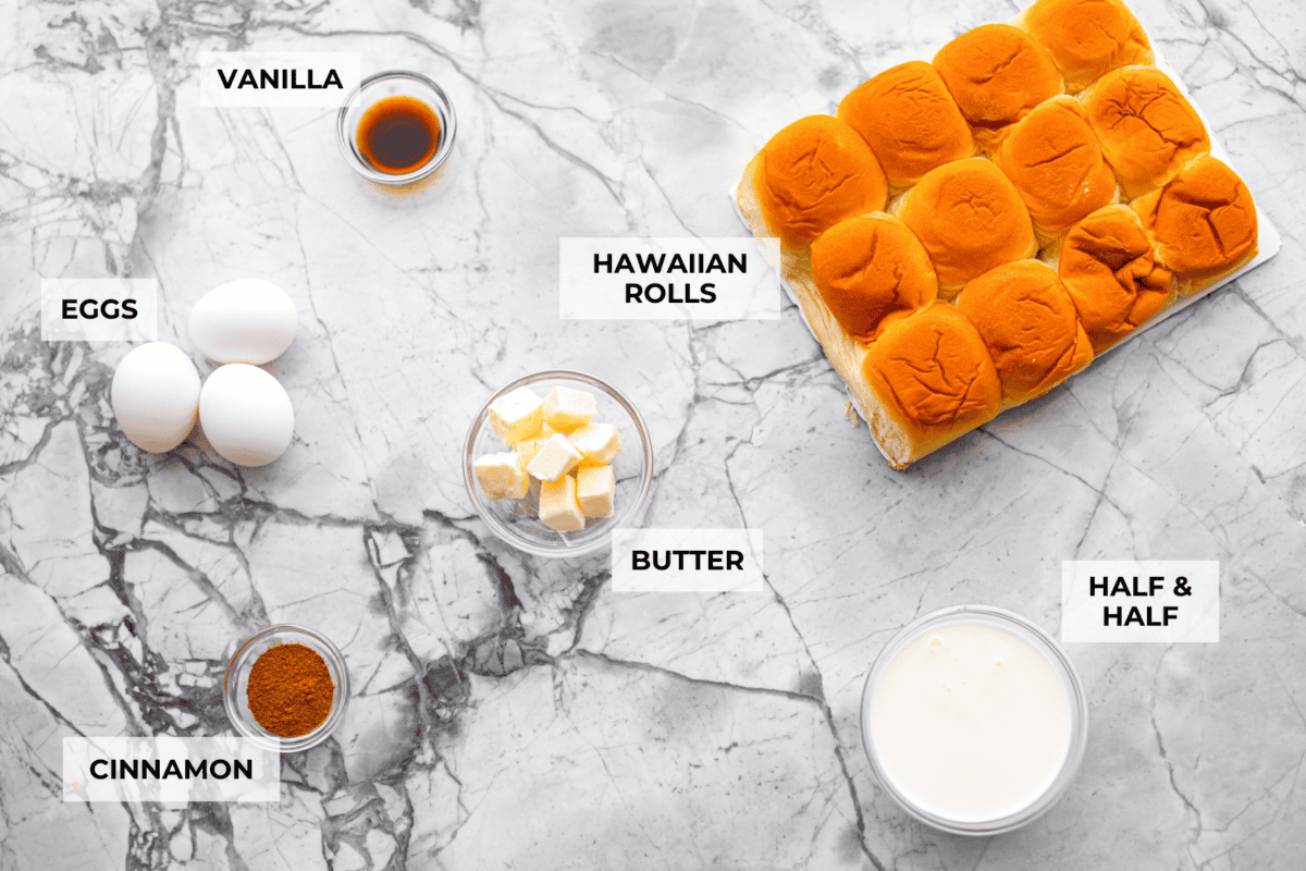 Hawaiian Roll French Toast is a fun twist on the classic, with sweet, buttery rolls that stay soft inside and turn golden outside. Instead of cutting them up, which made them too soggy, I used the whole rolls for the best texture. The real game changer was pairing them with my homemade coconut buttermilk syrup for an extra indulgent touch. Overhead shot of labeled ingredients.